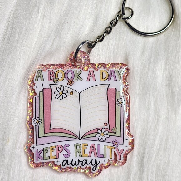 A Book A Day Keeps Reality Away Keychain - Picture 1 of 2